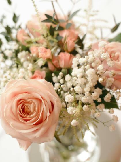 A wedding bouquet with pink and white flowers.